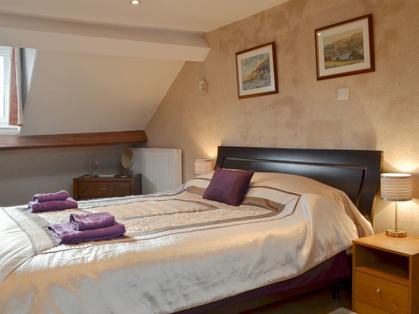 Wonderful bedroom with super kingsize bed, sloping ceilings and en-suite  | Bianca Rose, Keswick