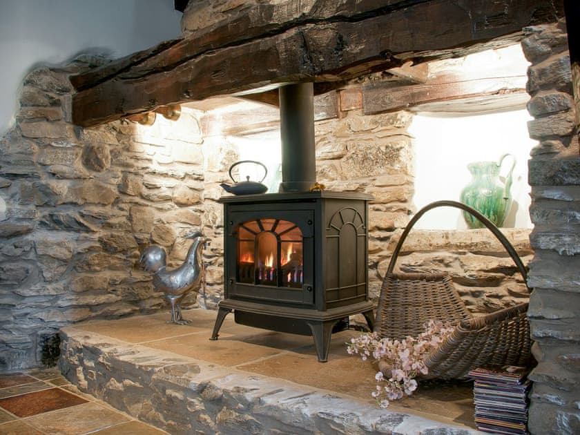 Feature fireplace with a wood effect gas burner | Staveley House - Staveley House & Staveley House Apartment, Staveley