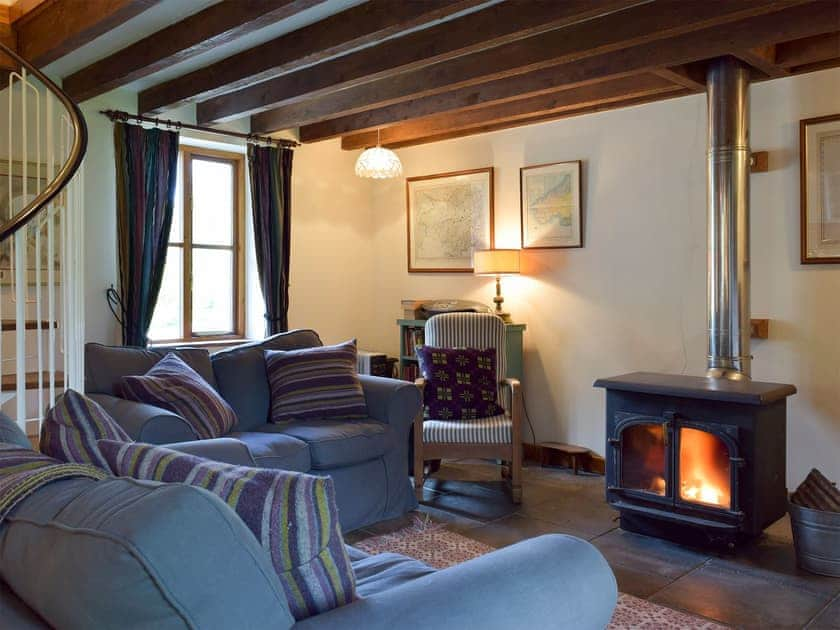 Comfortable and warm living area with wood burner | Y Bwthyn - Fachongle Ganol Cottages, Fachongle Ganol, near Newport