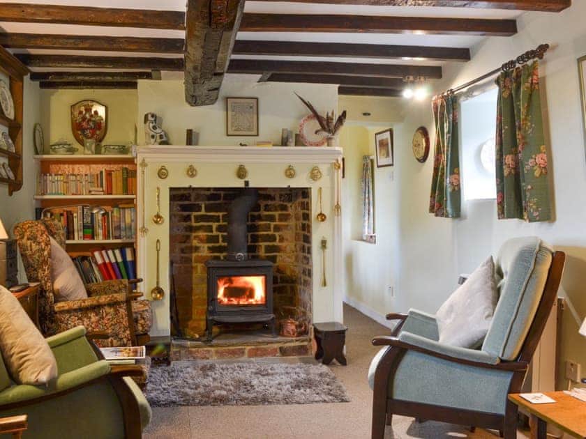 Cosy beamed living room | Upper Stanbatch Cottage, Wentnor, near Bishops Castle