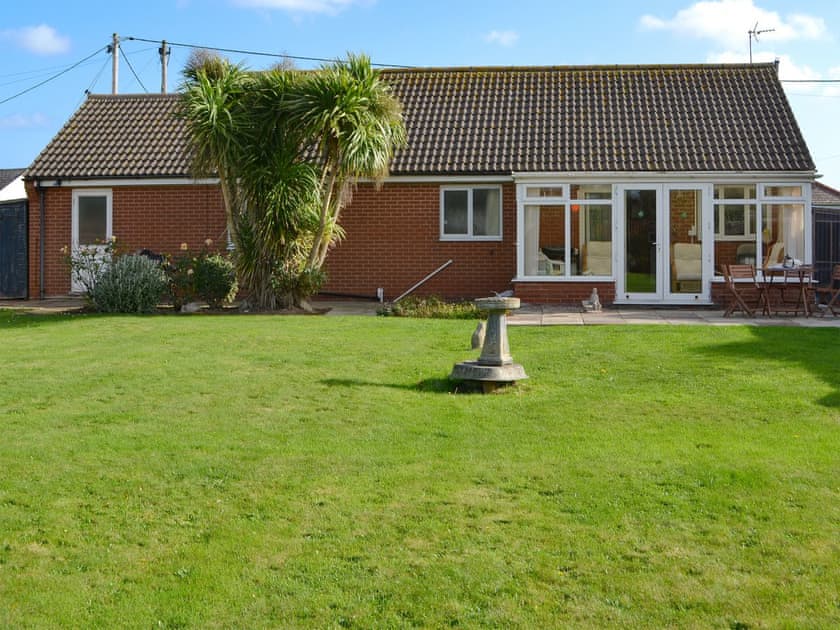 Spacious lawned garden | Rest-A-While, Walcott, near North Walsham