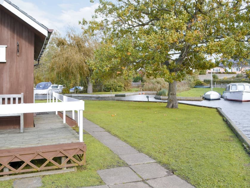 Garden area at the water’s edge | Silver Birches, Horning