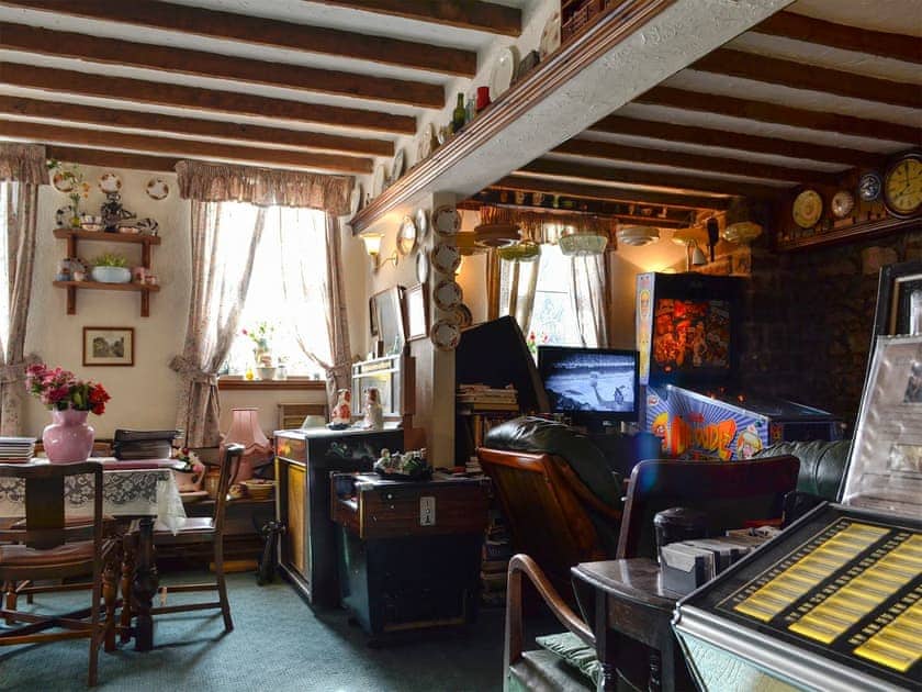 Quirky living room complete with pin ball machine | Chapel Cottage, Pontsticill, Brecon Beacons
