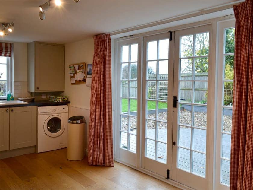 French doors from the kitchen lead onto a delightful terrace | Violet Cottage, Kingsdown, near Deal