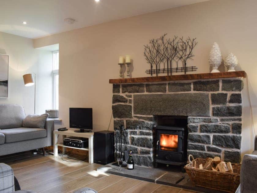 Cosy living area with wood burner | Craigmuick Cottage, Aberfoyle