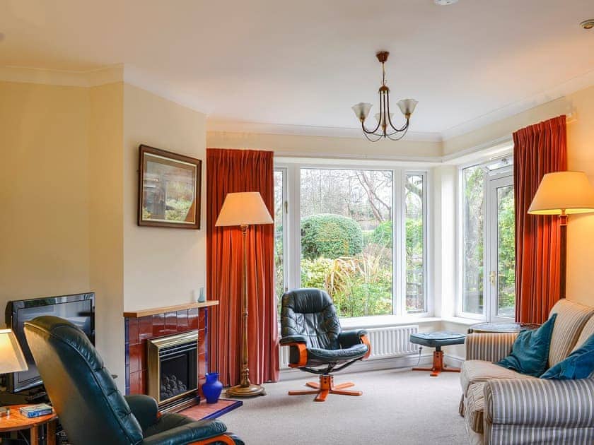 Spacious living area with large bay window | Belgravia Cottage, Skipton
