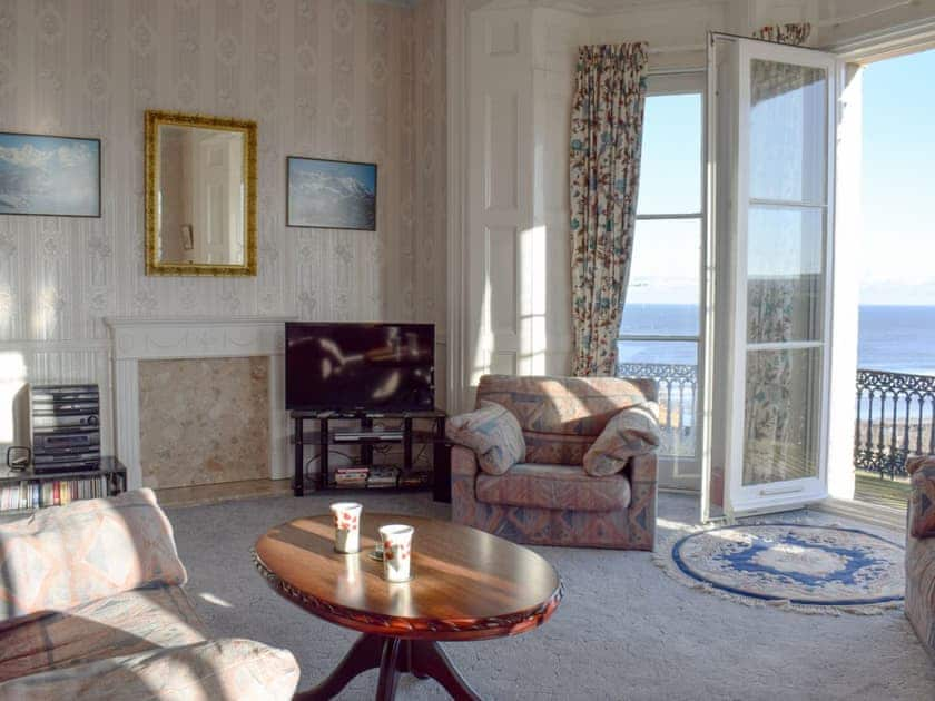 Comfortable living room with doors leading onto the balcony | Frank’s View, Saltburn-by-the-Sea