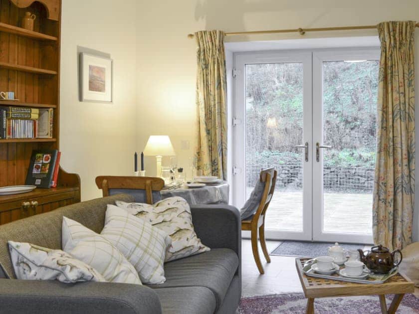 Convenient dining area within living room | Nettlebush Cottage - Drumelzier Place Farm, Drumelzier, near Peebles