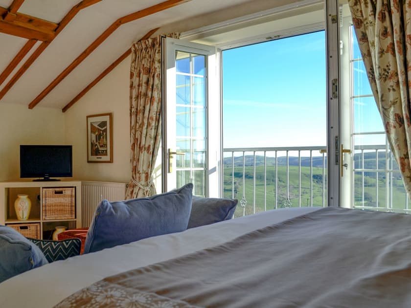 Light and airy bedroom with Juliet balcony | Meadow Croft - The Crofters Cottages, Llangeinor, near Bridgend