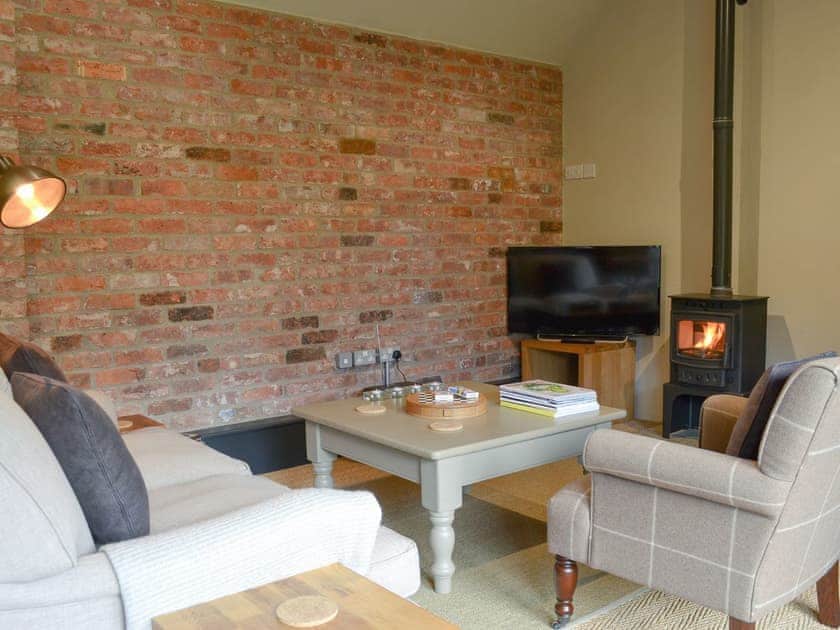 Delightful living area, with a cosy wood burner | The Bolthole, Tibthorpe, near Driffield