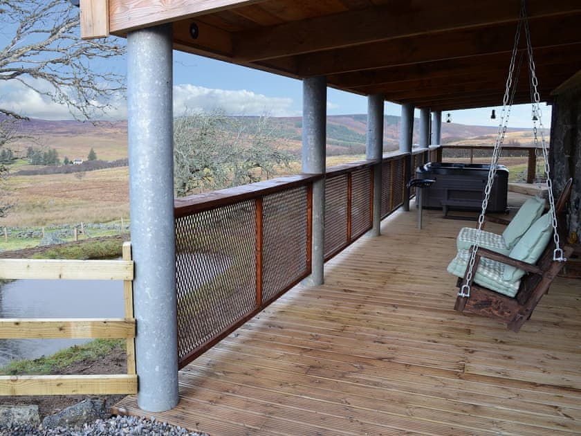 Wooden covered veranda with seating and hot tub | Capercaillie Cottage, Rhilochan, Rogart, near Dornoch