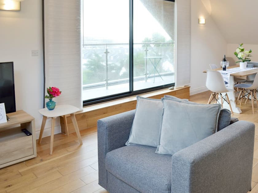 Open-plan living area with patio door to balcony | Lyndhurst, Perranporth