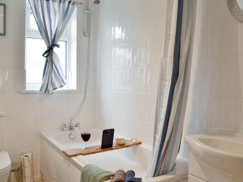 Family bathroom with shower over bath | Church Court Cottage, Beeford, near Hornsea