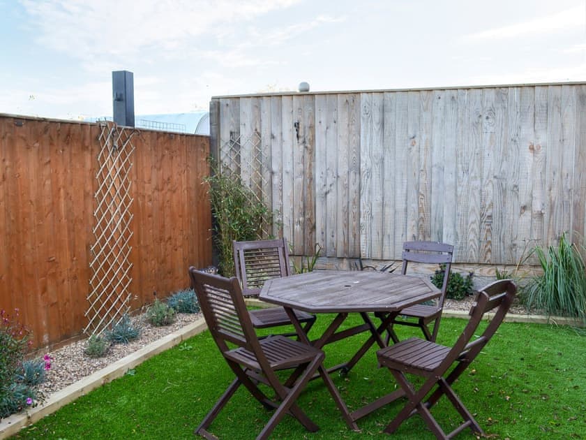 Enclosed courtyard with sitting-out area and garden furniture | Ravenna, Anderby Creek, near Skegness