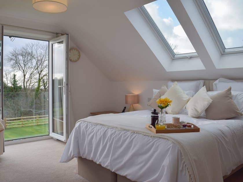 Wonderful large double bedroom with double doors to the Juliet balcony | Ivy Bush Cottage, New Moat, near Narberth