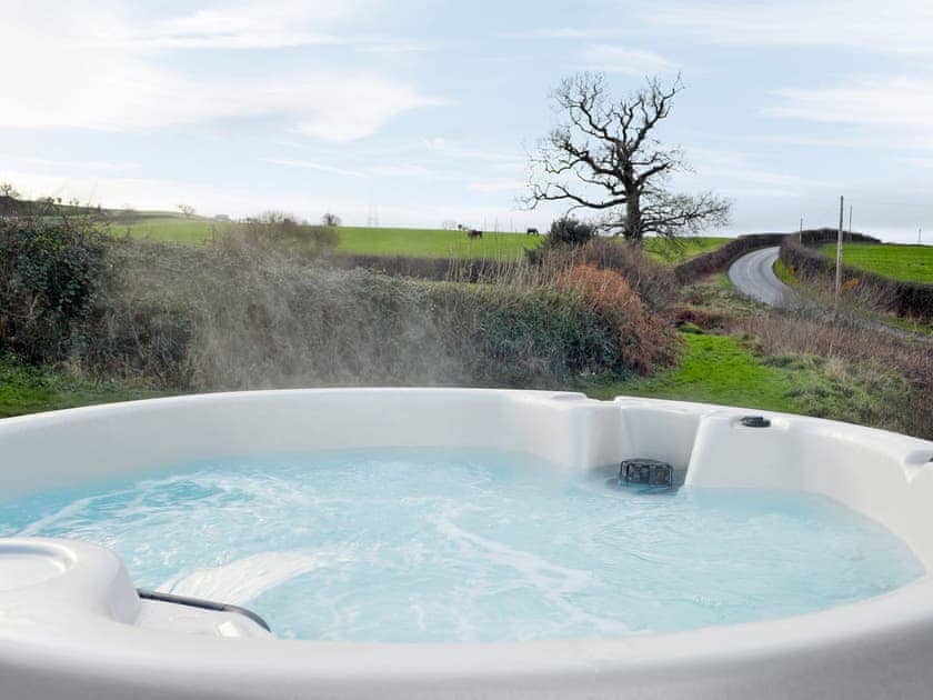Relaxing hot tub | The Coach House - Peniarth Bach Farm, Betws-Yn-Rhos, Conwy