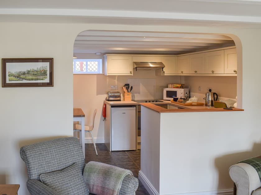 Delightful kitchen/dining area separated by an archway from the living room | Rowan Cottage, Aislaby, near Whitby