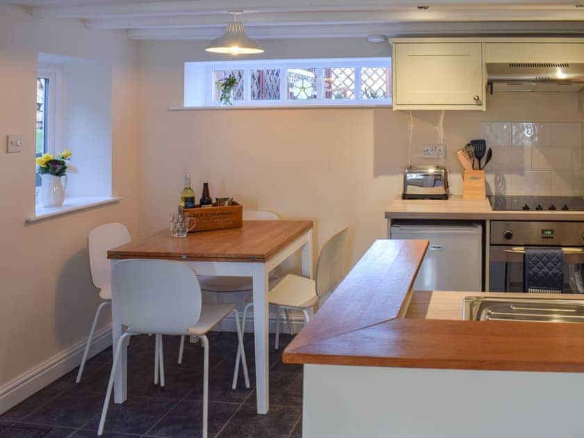 Compact dining area and adjacent kitchen | Rowan Cottage, Aislaby, near Whitby