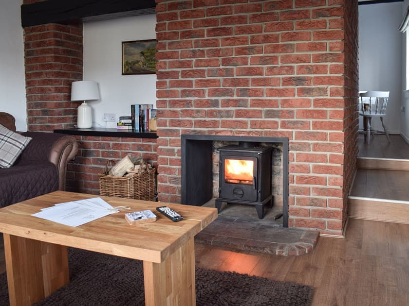 Living room with wood burner | Yew Tree Cottage, West Ayton, near Scarborough