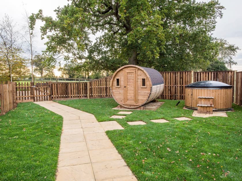 Enclosed lawned garden with patio, garden furniture and hot tub | Meadowsweet Cottage - Swardeston Cottages, Swardeston, near Mulbarton