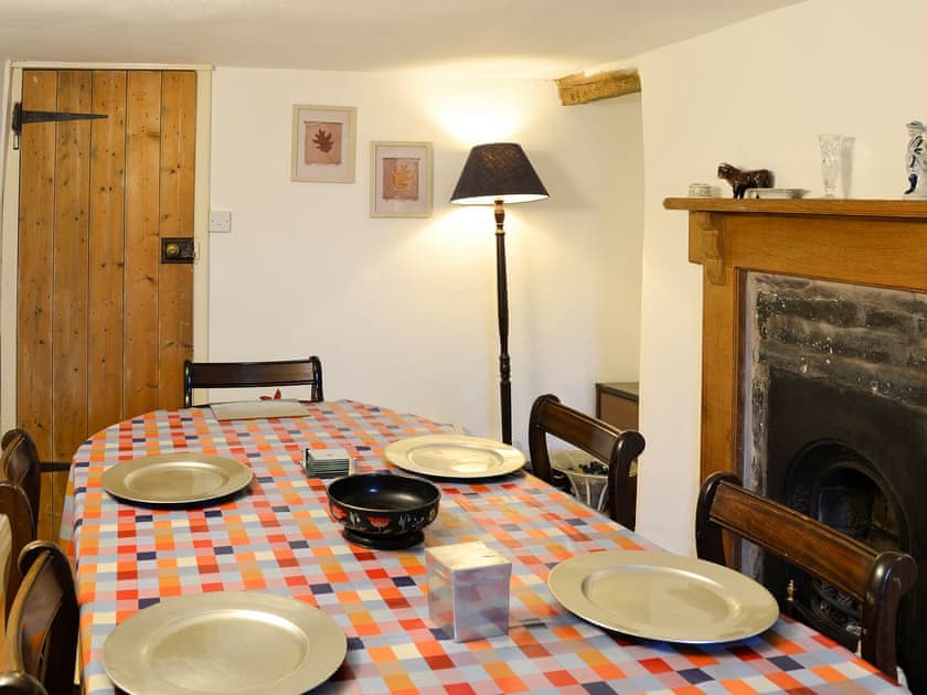 Lovely cottage dining room with feature fireplace | Hen Hafod, Bala