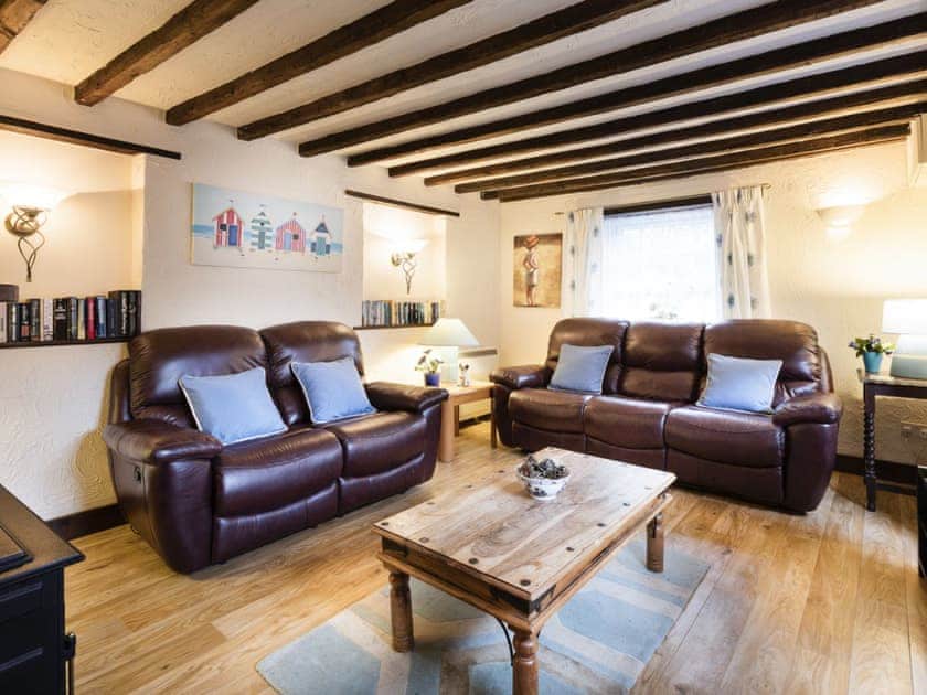 Charming beamed living room with open fire  | Pitts Cottage, Brancaster