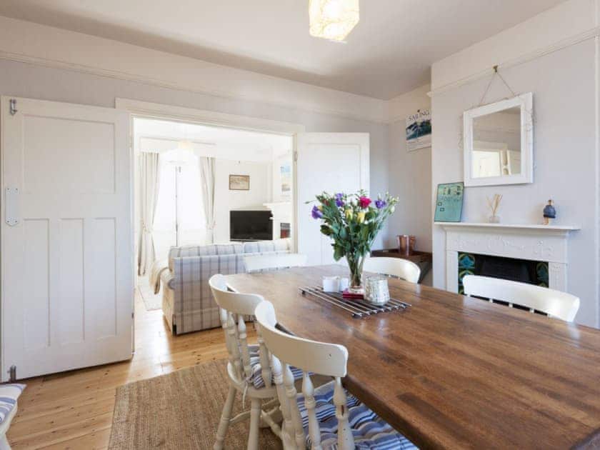 Spacious wood-floored dining room with double doors to the living room | Torrings, Salcombe