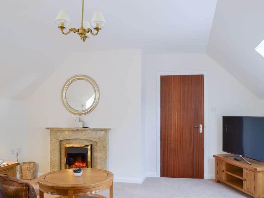Lovely living room with electric fire | The Willows, Inverness