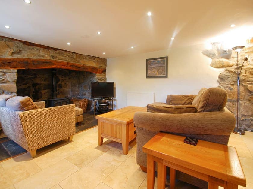 Tile-floored living room with large open fireplace | Ty Newydd, Llyn Geirionydd, near Llanrwst