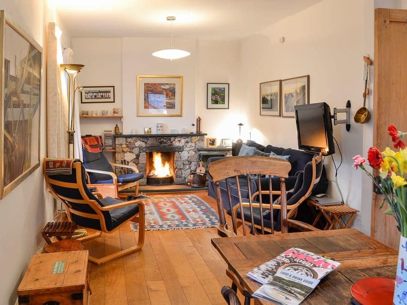 Warm and cosy living/dining room with open fireplace | The Larches, Seldom Seen near Thornthwaite