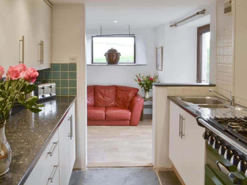 Fully-appointed kitchen with open aspect to dining room | Mad Nelly Cottage - Wheeldon Farm Cottages, Halwell, near Totnes