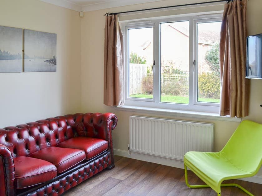 Comfy snug with TV and leather sofa | Sand Castles, Seahouses