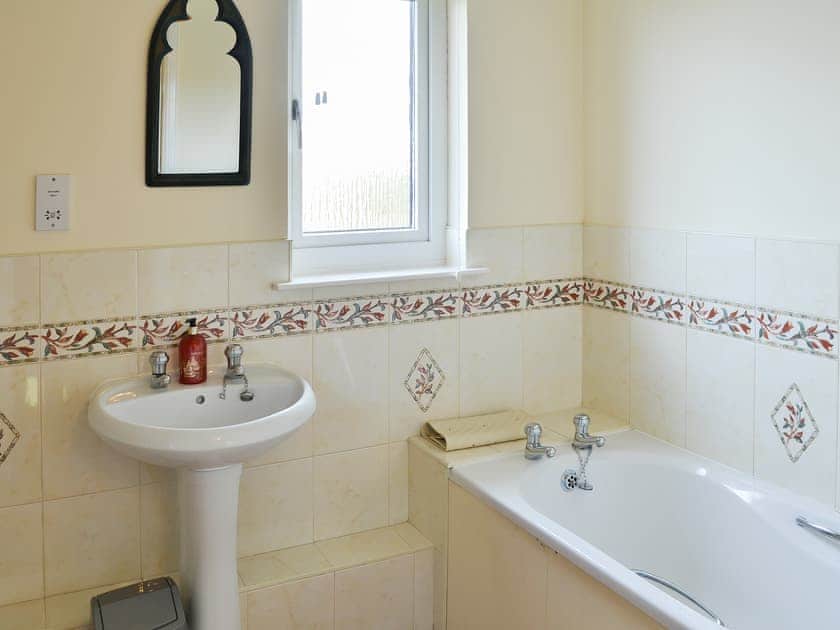 Tiled bathroom with bath and shower cubicle | Sand Castles, Seahouses