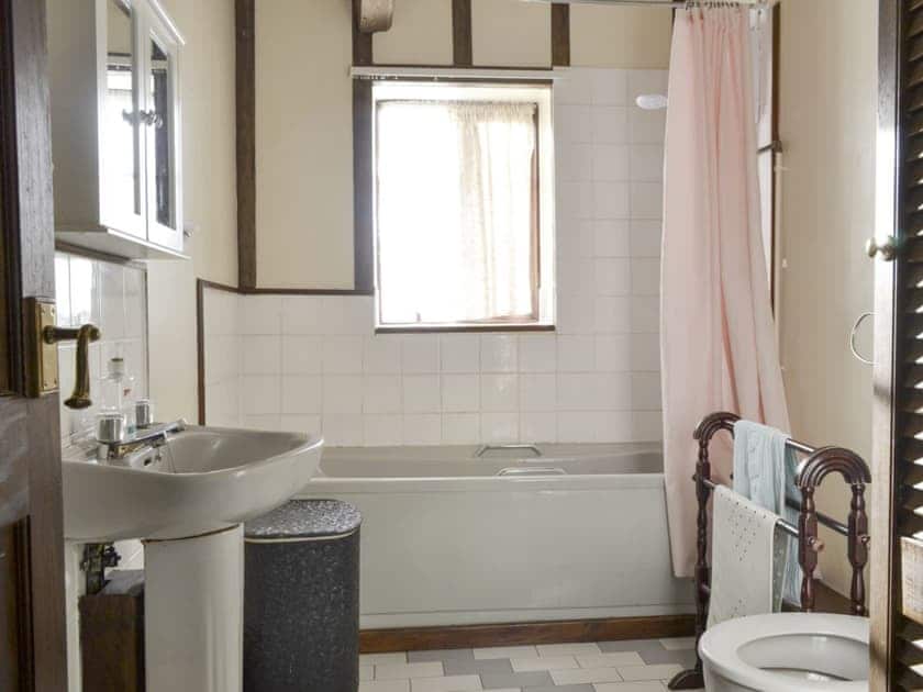 En-suite bathroom with shower over bath | Grove Sprightly Barn, Craven Arms