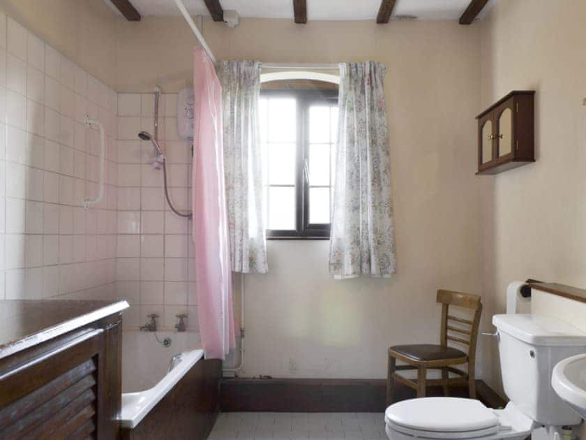 Bathroom with shower over bath | Grove Sprightly Barn, Craven Arms