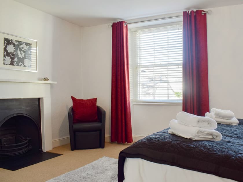 Double bedroom with feature fireplace | Warner Lea, Bowness, near Windermere