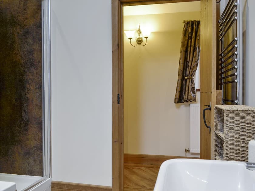Family bathroom with shower cubicle, bath and heated towel rail | The Old Byre - West House Farm, Dearham, near Maryport