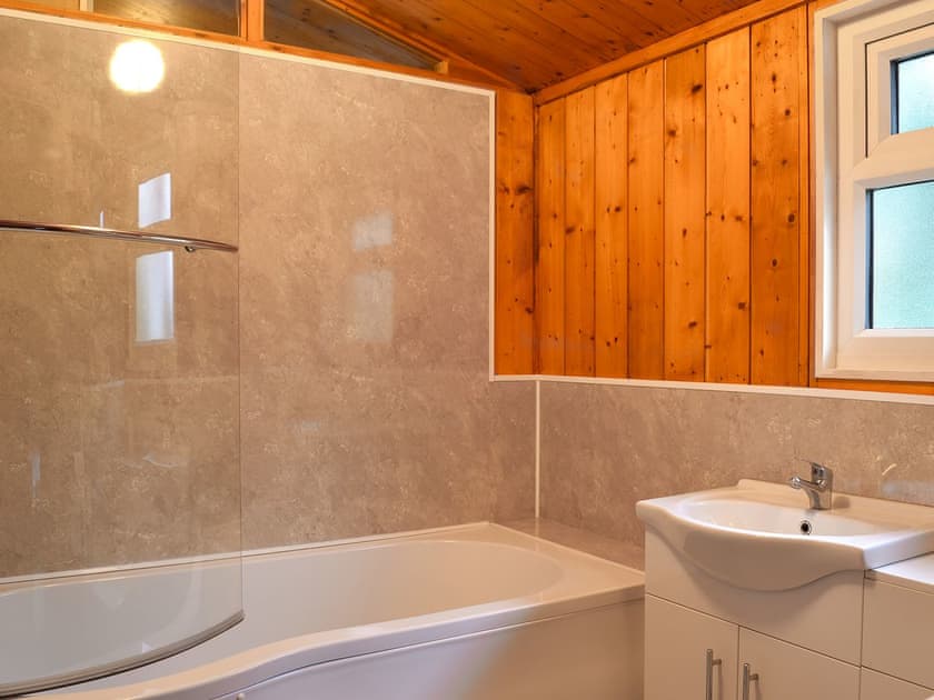 Tiled en-suite bathroom with shower over the bath | Cedar Lodge, Charlcot, near Masham