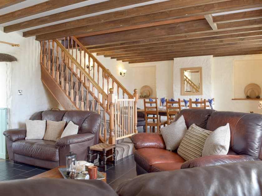 Characterful living/ dining room with beamed ceiling | Bryntowy - Tanylan Farm Cottages, Kidwelly
