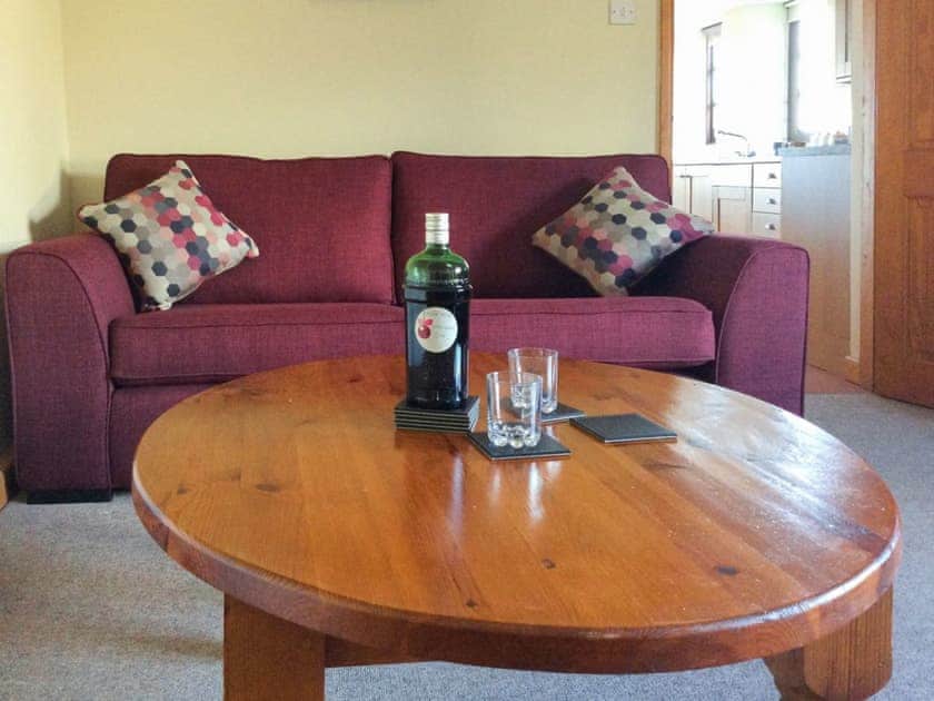 Relax and unwind in the warm and welcoming living room | The Pump House, Hawkesbury Upton