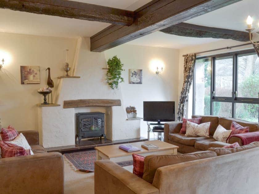 Welcoming living room with wood burner | Dray Cottage, East Allington, near Totnes