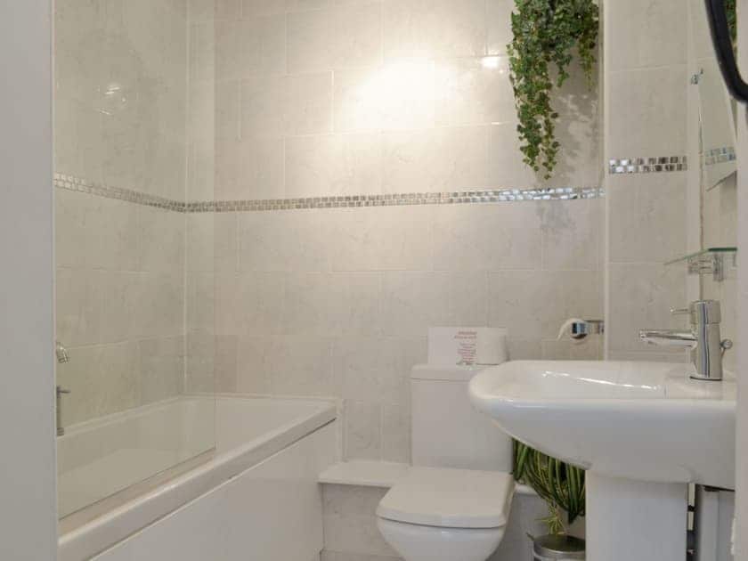 Family bathroom with shower over bath | Dray Cottage, East Allington, near Totnes