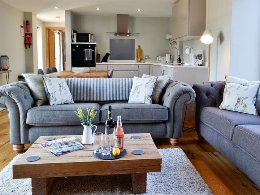 Open plan living space with beams and oak floors  | Maes Merlin, Llanddeusant, near Llangadog