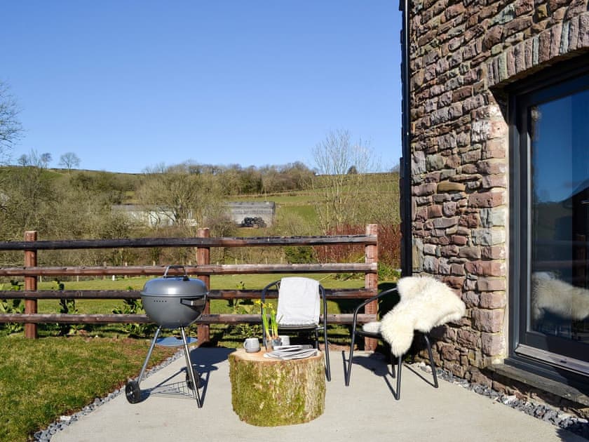 Patio with garden furniture and BBQ | Maes Merlin, Llanddeusant, near Llangadog