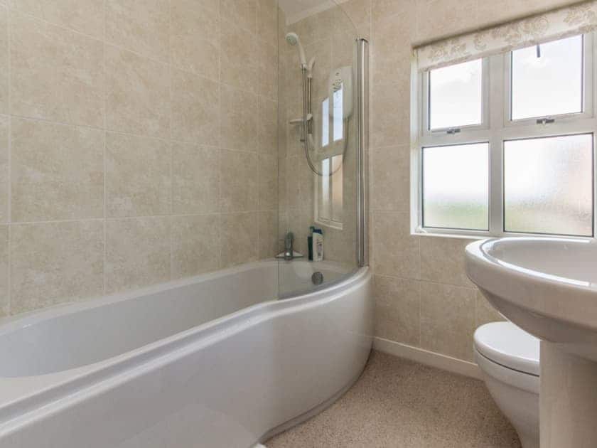 Family bathroom with shower over bath | Coastguard Cottage, Sandown