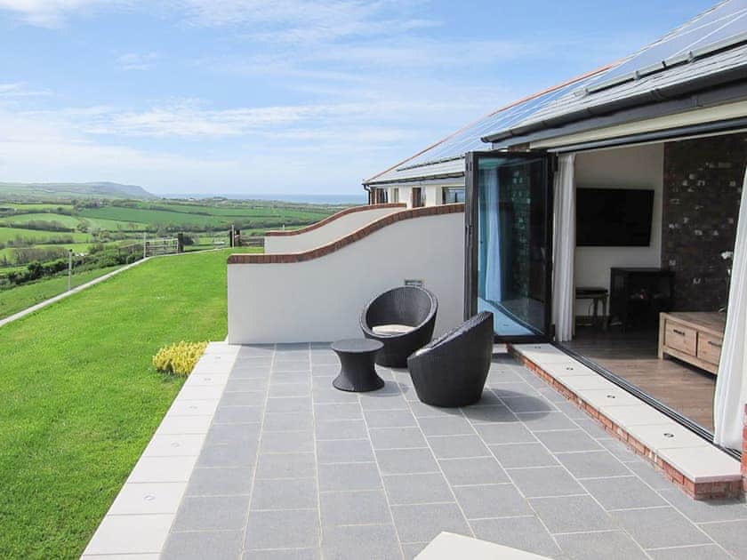 Wonderful far reaching view from your own private patio | Moonshine - Wooldown Holiday Cottages, Marhamchurch, near Bude