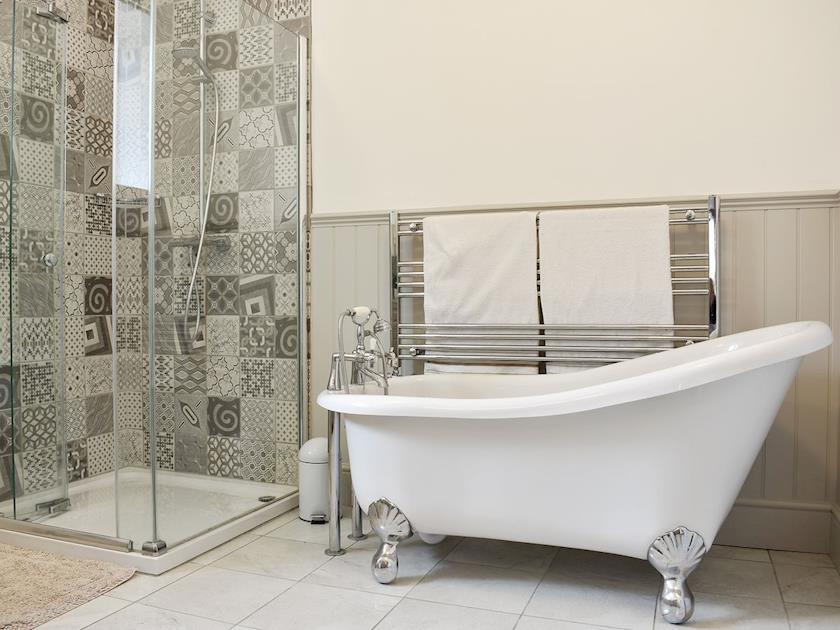 Well presented bathroom with roll top bath and separate shower cubicle | Coach House, Wareham