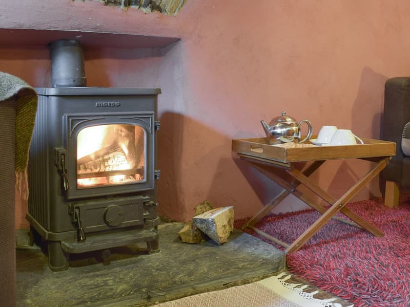 Warming wood burner within living room | 2 Penrhiw, Abercych, near Newcastle Emlyn