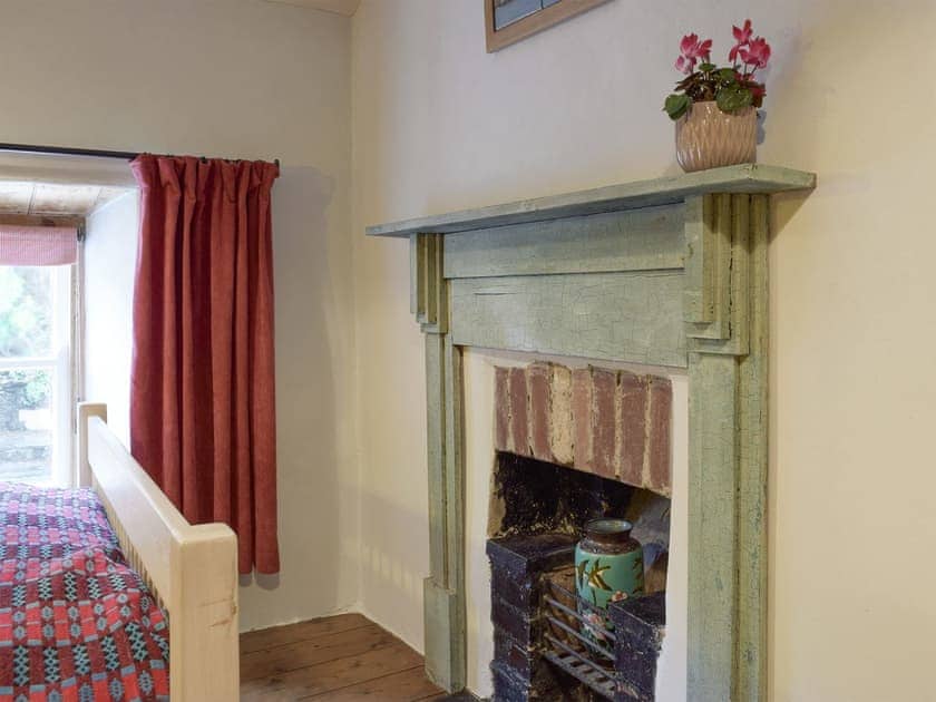 Characterful fireplace within double bedroom | 2 Penrhiw, Abercych, near Newcastle Emlyn