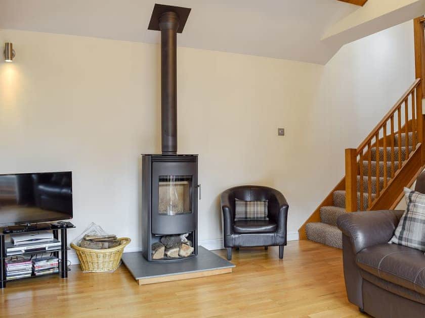 Cosy wood burner in the living area | The Hayloft, Kidderminster